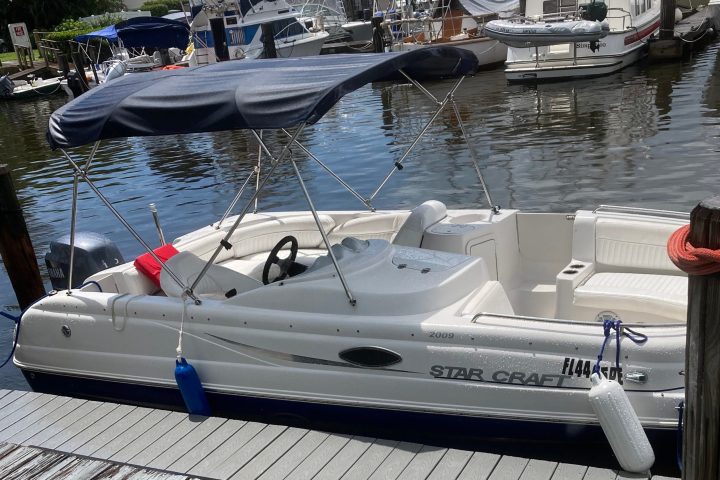 a boat that is sitting on a dock next to a body of water